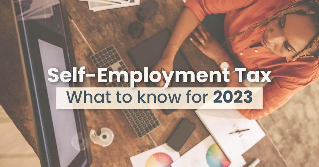 A woman working at a desk with a computer, papers, and a coffee cup, with text overlay about "self-employment tax what to know for 2023.